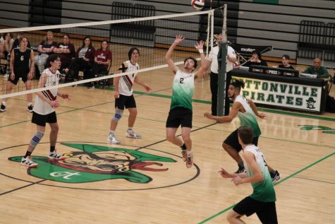 Matthew Reese (12) sets the ball to Justin Bowers (12) for a kill against Rockwood Summit on April 25. Reese had 578 assists throughout the season, with an average of eight assists per game.