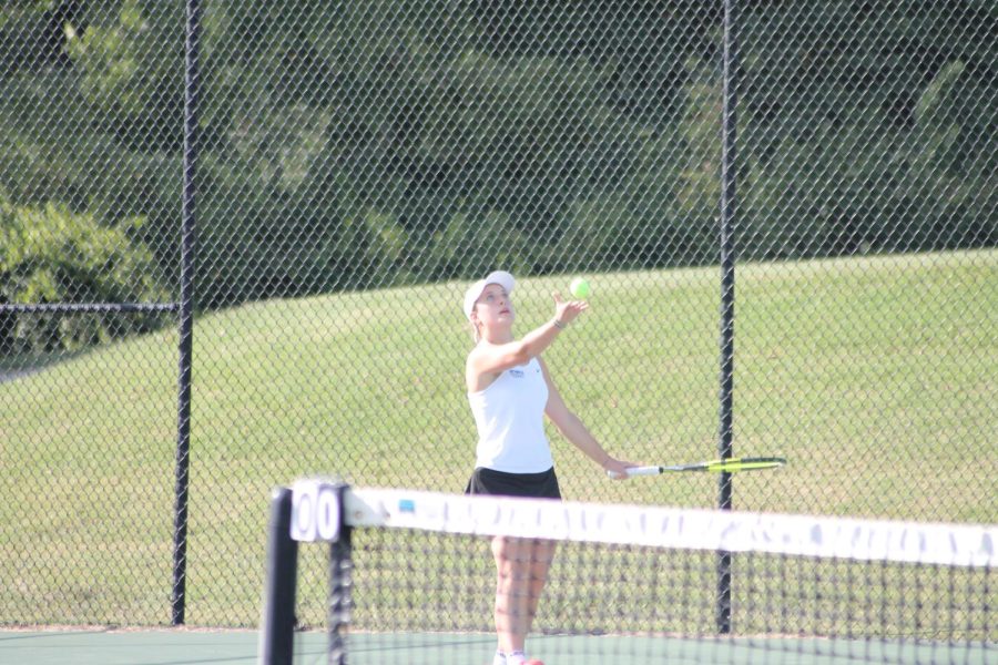 Senior and Captain Emma Artlet serves in her singles match against Lutheran High School.