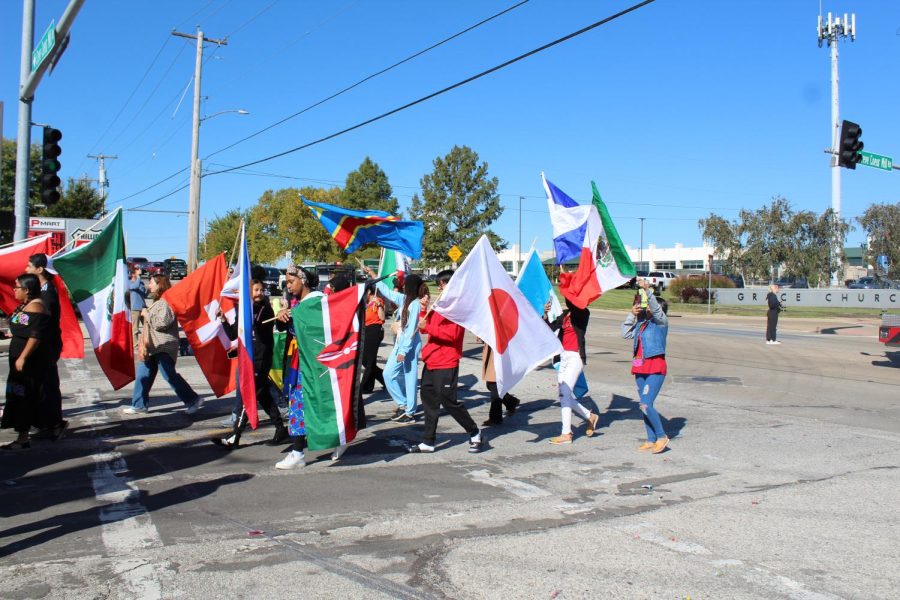 International Club walks in the Homecoming Parade, carrying the flags of over 15 countries. “I believe all students should learn at least three languages, Faisal Yousif said. I think having access to more languages and other cultures is a beautiful thing. It also allows for more communication with other parts of the world, and it is great for traveling. Also, is there a reason to NOT learn a second language? other than procrastinating of course.