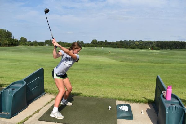 Junior Zelletta Wyatt gets ready to drive the ball down the range at a practice. 