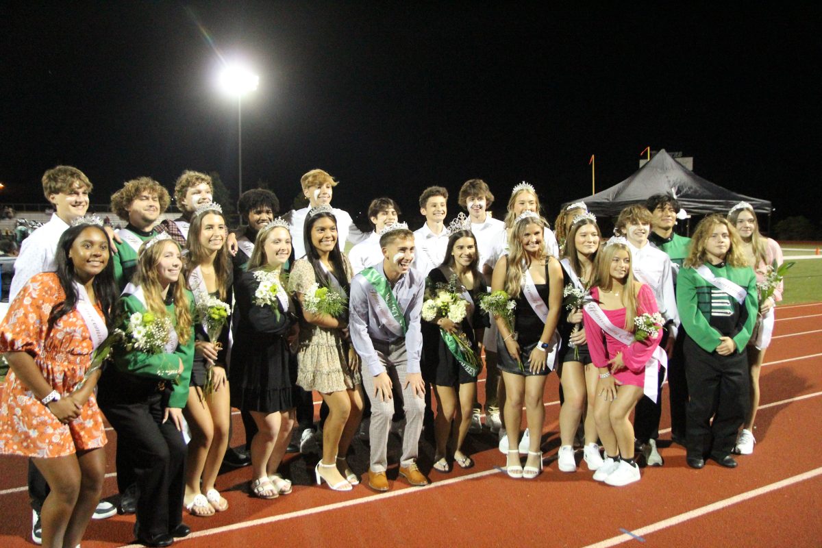 All of the Homecoming Court members surrounding the Homecoming King Paul Palermo and Homecoming Queen Emily Kramer.