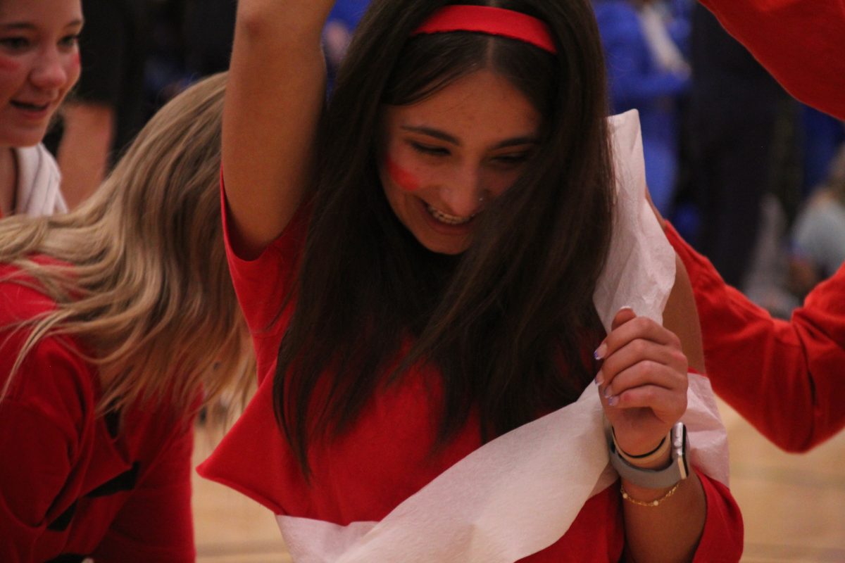 Junior Isabella HutchinsonDiBello participating in the Build a Snowman game at the October 13 Pep Rally