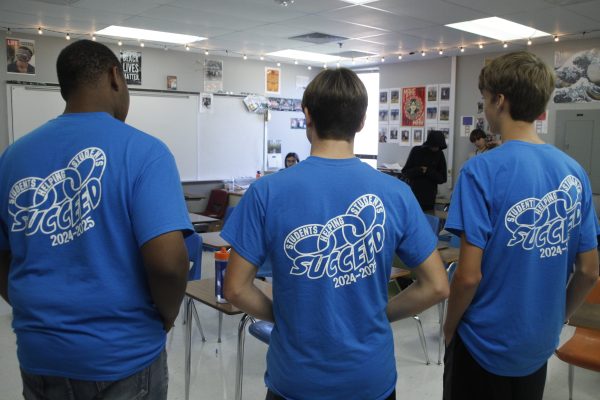 Link Crew leaders speak in a freshmen homeroom, guiding activities that improve bonds and relationships.