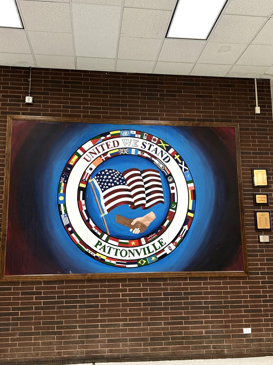 The plaque on the mural reads "United WE Stand, Pattonville, all races and languages... we stand together." 