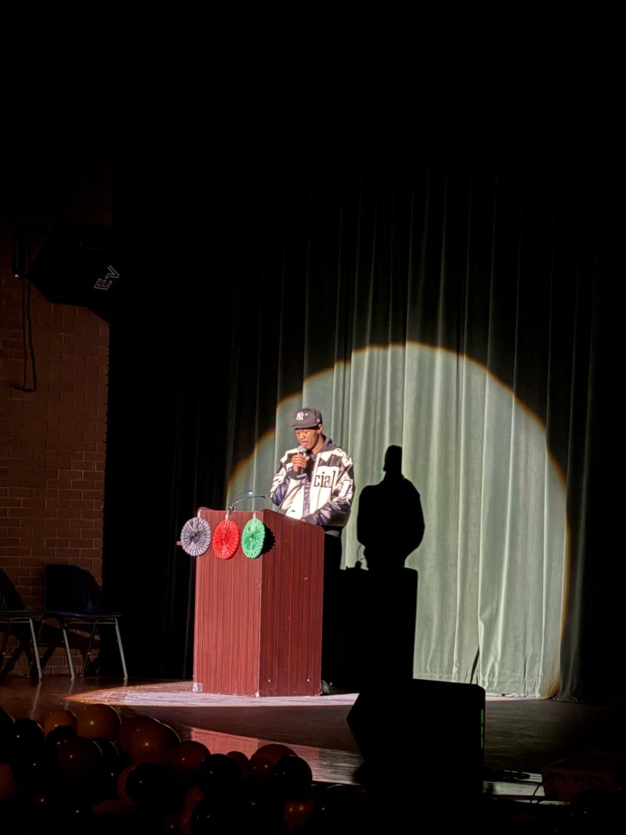 Junior Kaleb Goodwin introduces the 1990s during the "Us Through Time" production. 