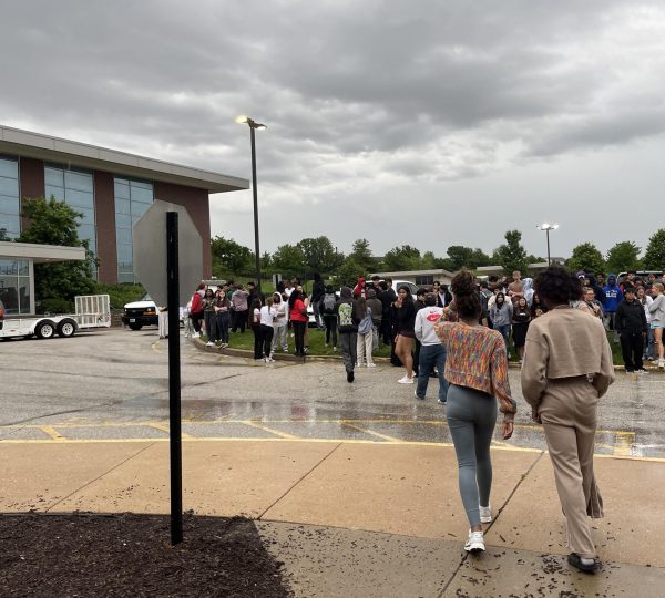 Students walking to their safe place outside by the B-wing during the fire drill.